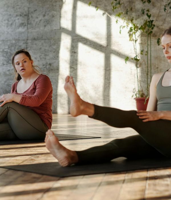 Woman starting her morning with a calm, focused yoga stretch in a serene setting.